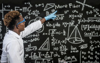 Scientists Wear Glasses And Point To Formulas On The Blackboard